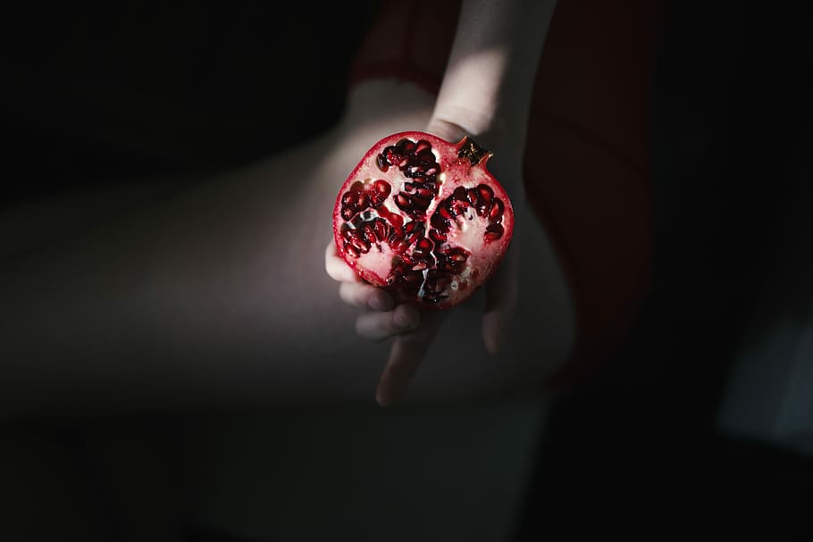 person holding red pomegranate, pomegranate fruit, dark, hand HD wallpaper