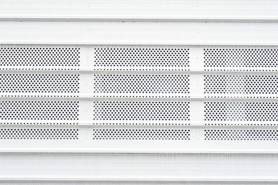 white architectural building, rectangular white metal sheet with holes