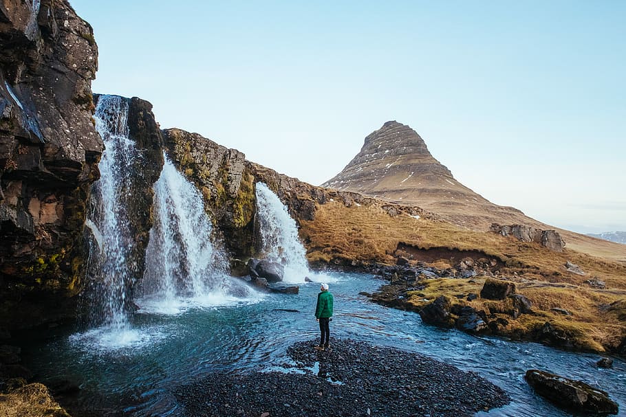 man standing near waterfalls, man standing on heart-shaped ground near waterfalls HD wallpaper