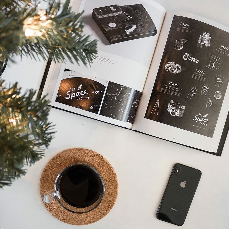 photo of space gray iPhone 8 beside glass and brochure, space gray iPhone X beside clear glass mug HD wallpaper