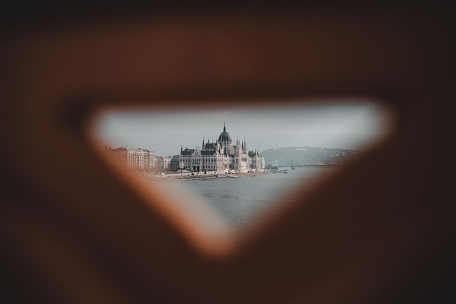 hole seeding large body of water across castle, selective focus photography of cathedral near body of water HD wallpaper