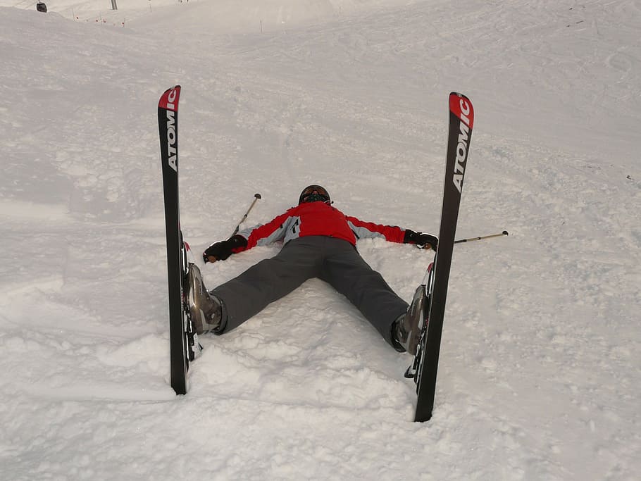person lying on snowfield, skiers, tired, concerns, exhausted
