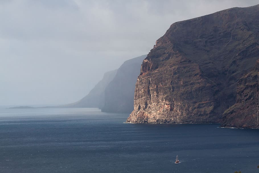 sailing boat near rock cliffs, los gigantes, tenerife, santiago del teide
