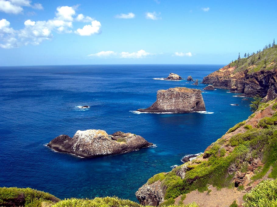 photo of body of water ocean waves green grass mountain, cliff HD wallpaper