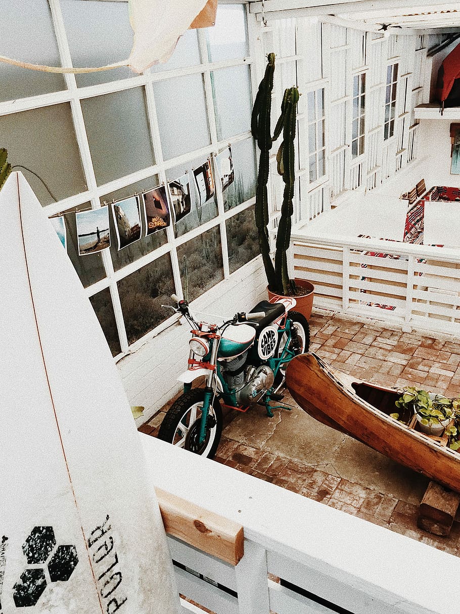 green motorcycle beside a brown wooden boat, green and black bobber motorcycle HD wallpaper