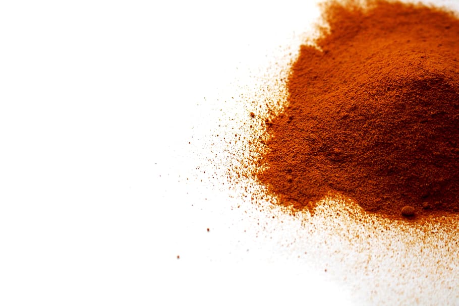 close up photo of brown powder, turmeric, spice, asian, flavor