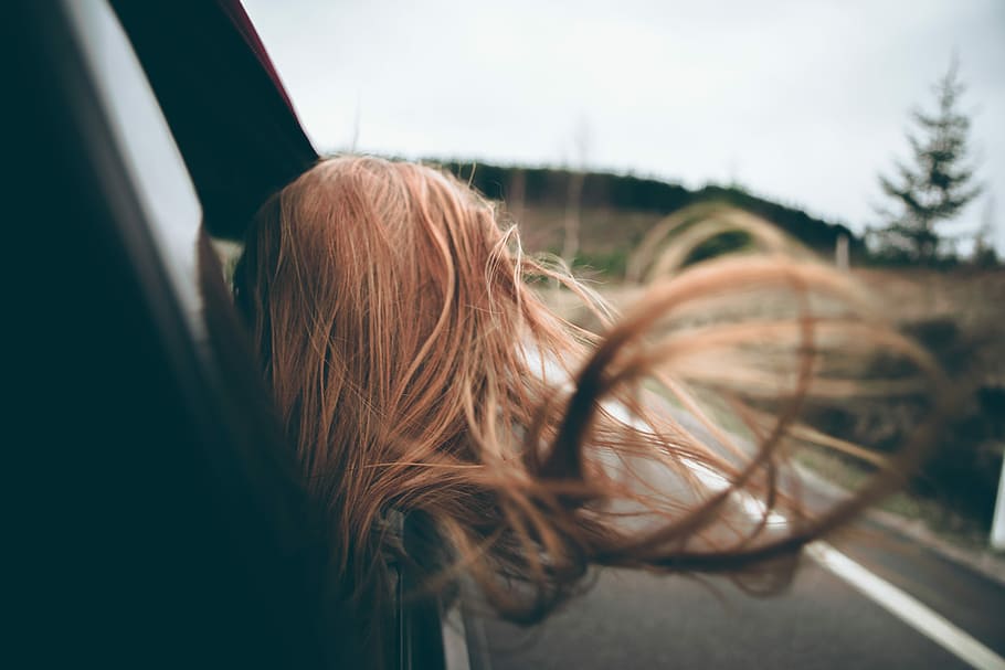 woman looking outside car window, brunette haired woman looking out of car window on road during daytime