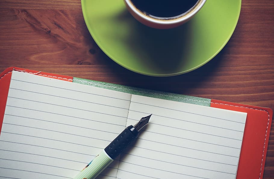 black and white ink pen on white ruled notebook, coffee, wooden HD wallpaper