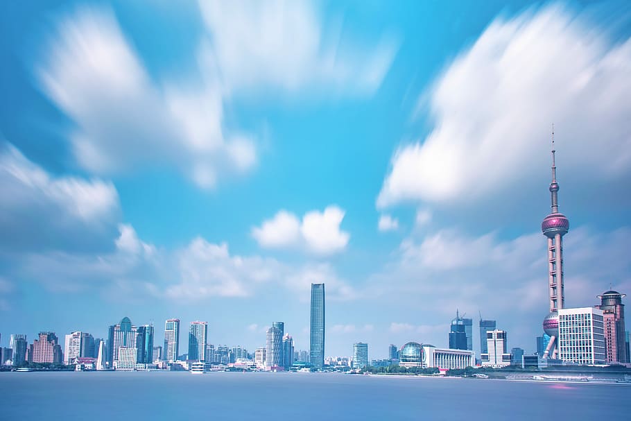high-rise buildings, gray concrete buildings under blue sky and white clouds during daytime HD wallpaper