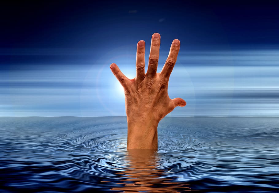 photo of human hand on body of water, sea, wave, clouds, help