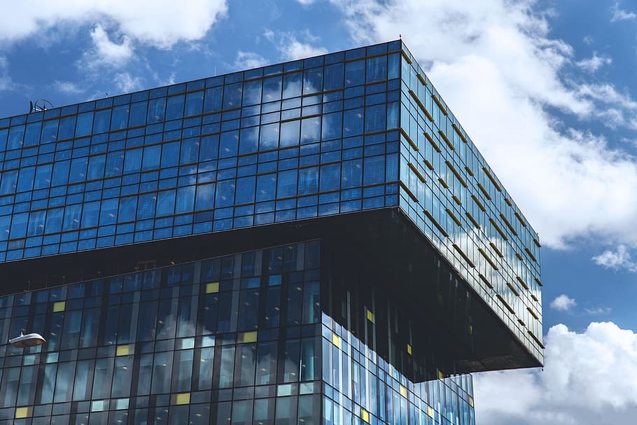 Glass office building captured against a blue sky, architecture HD wallpaper