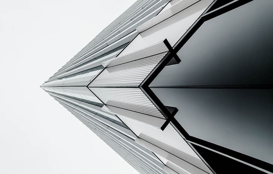 low-angle photography of black and gray building under white sky at daytime, low angle photography of gray building at daytime HD wallpaper