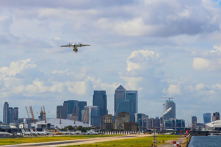 plane above pathway, white, aircraft, flying, mid, clouds, architecture HD wallpaper