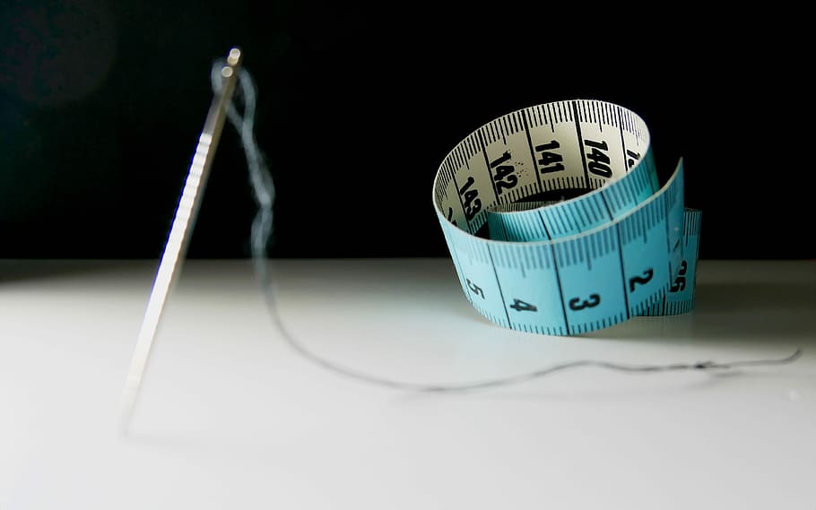 needle and tape measure on tale, scale, weight, precision, equipment