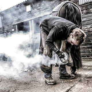 man standing on gray cement, fair, blacksmith, shoe, iron, craftsman HD wallpaper