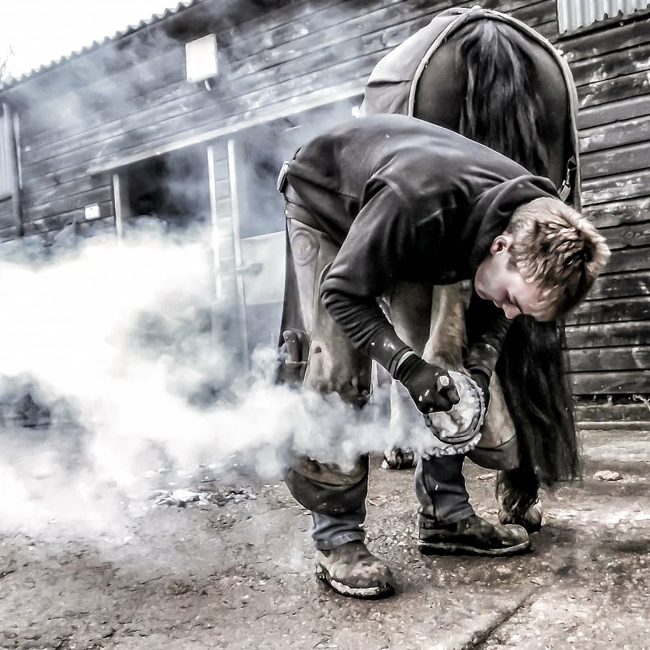 man standing on gray cement, fair, blacksmith, shoe, iron, craftsman HD wallpaper