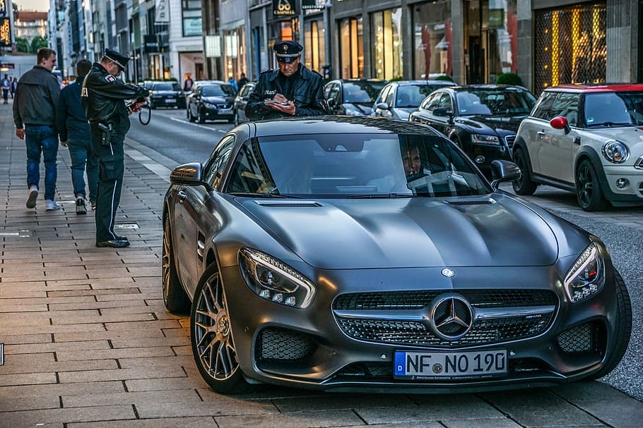 close-up photography of matte black Mercedes-Benz coupe on street at daytime