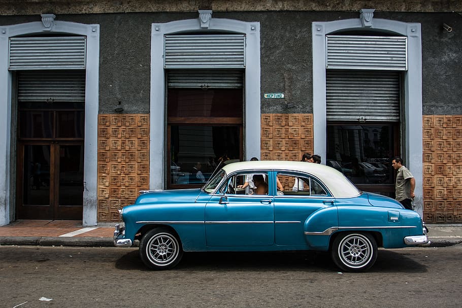 A classic car sits on an old street in Havana, Cuba. Image captured with a Canon DSLR HD wallpaper
