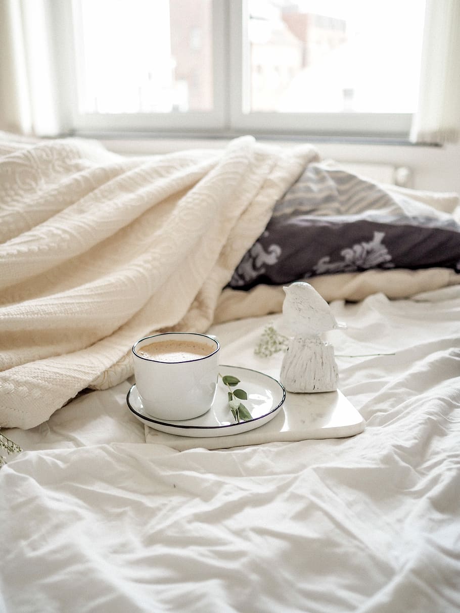 teacup filled with liquid placed on saucer, white ceramic coffee mug filled with brown liquid served on white saucer during daytime HD wallpaper