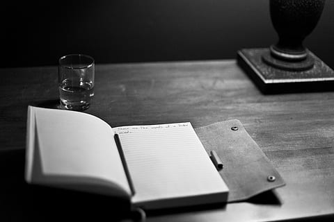 notebook on top of table monochromatic photography, manuscript HD wallpaper