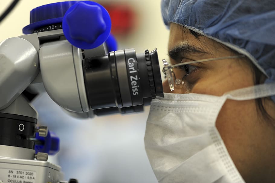 person using microscope, doctor, technology, transplant, operation
