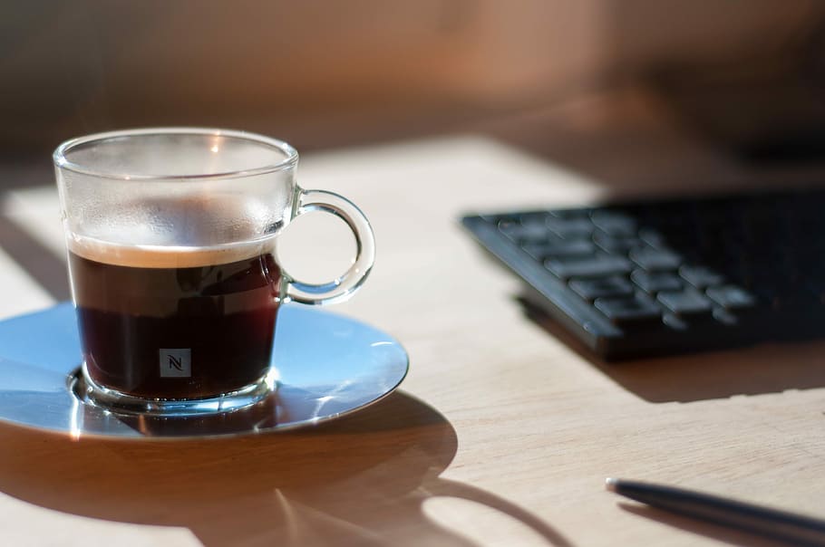 clear glass tea cup beside keyboard, clear glass cup filled with coffee HD wallpaper