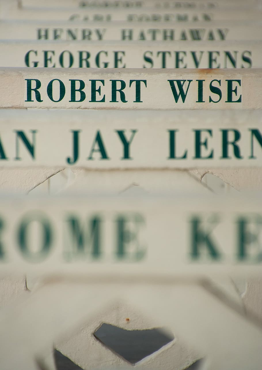 selective focus photography of Robert Wise folder, selective focus photograph of Robert Wise printed white surface HD wallpaper