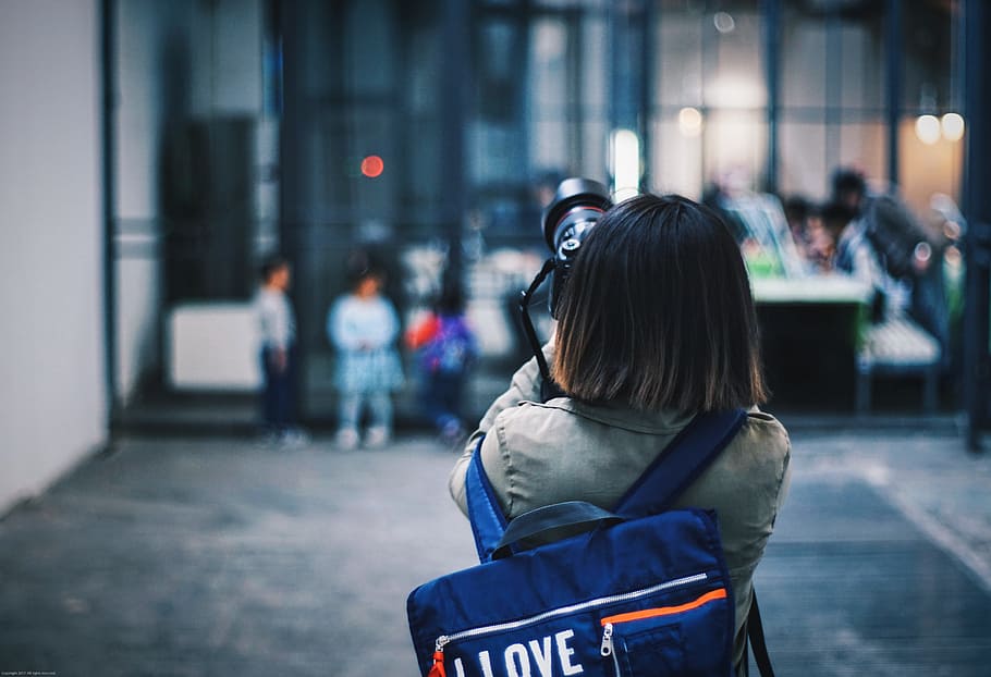 person taking picture of the building in selective focus photography, woman holding black camera DSLR taking picture HD wallpaper