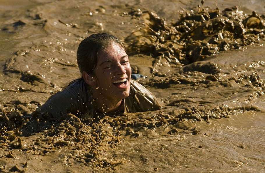 person submerged in mud, crawl, competition, race, obstacle, feet