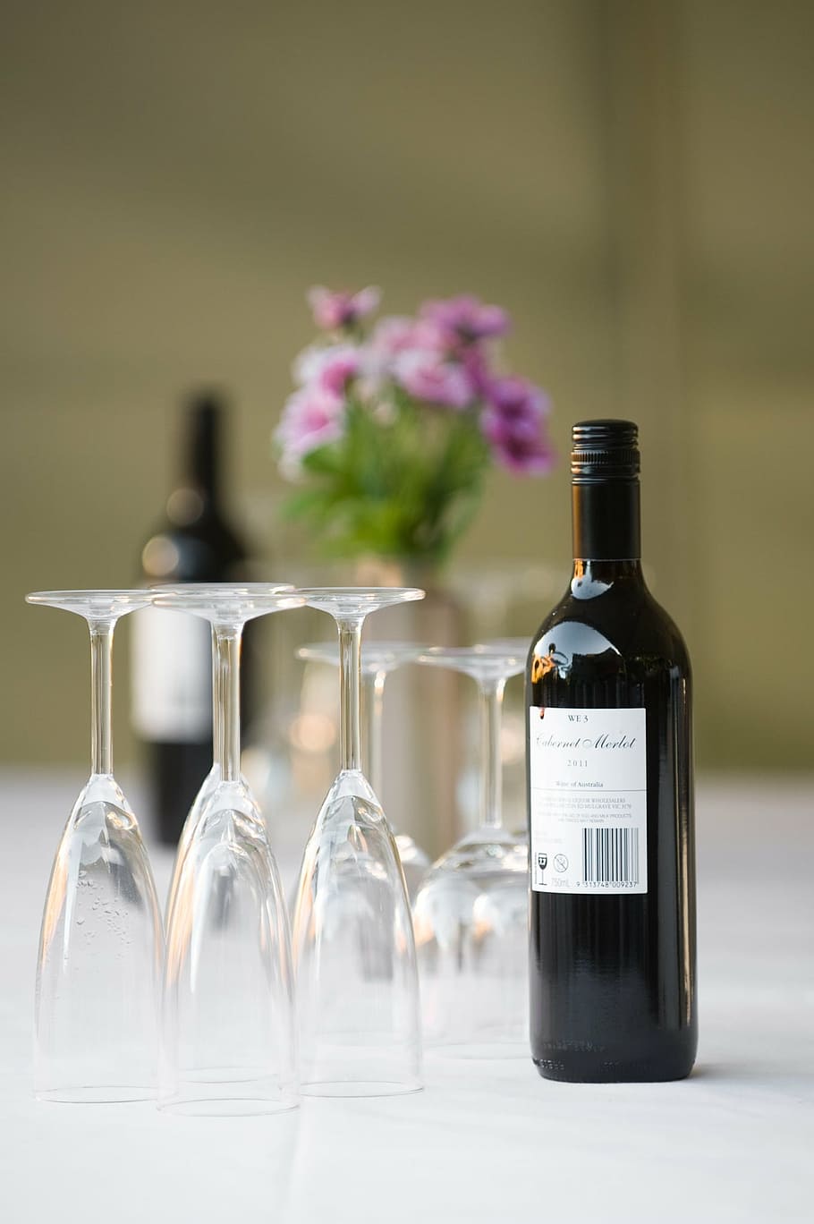 selective focus photograph of wine bottle and glass on white surface HD wallpaper
