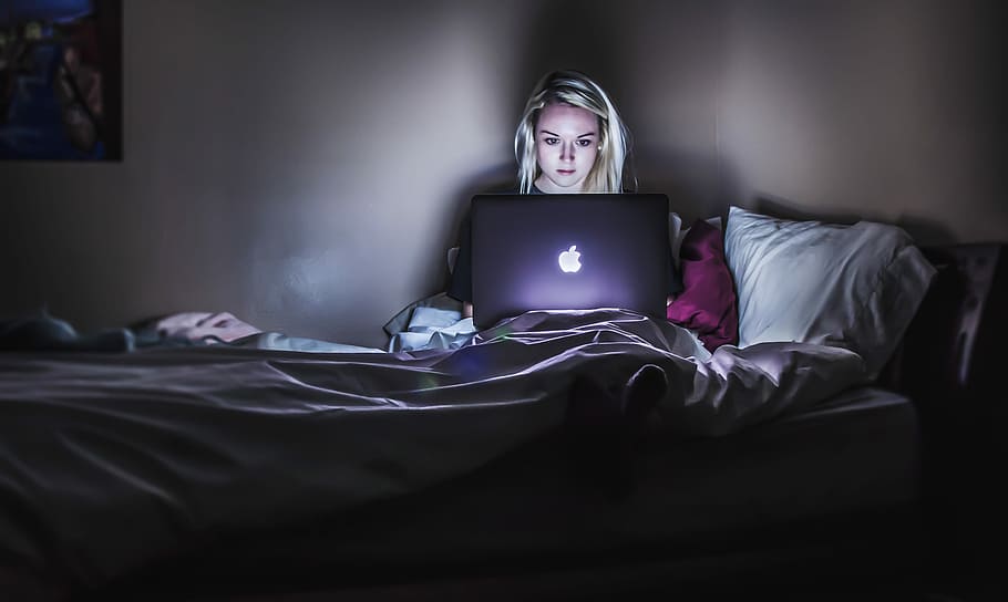 woman sitting on bed with MacBook on lap, woman using MacBook sitting on bed HD wallpaper