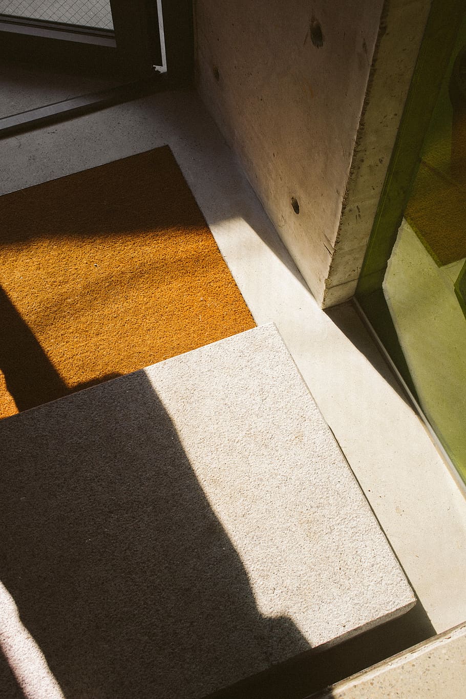 brown floor rug near opened door, gray concrete slab, mat, building HD wallpaper