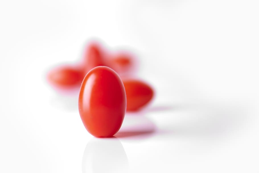 oval red candy in tilt shift photography, date tomato, tomatoes HD wallpaper
