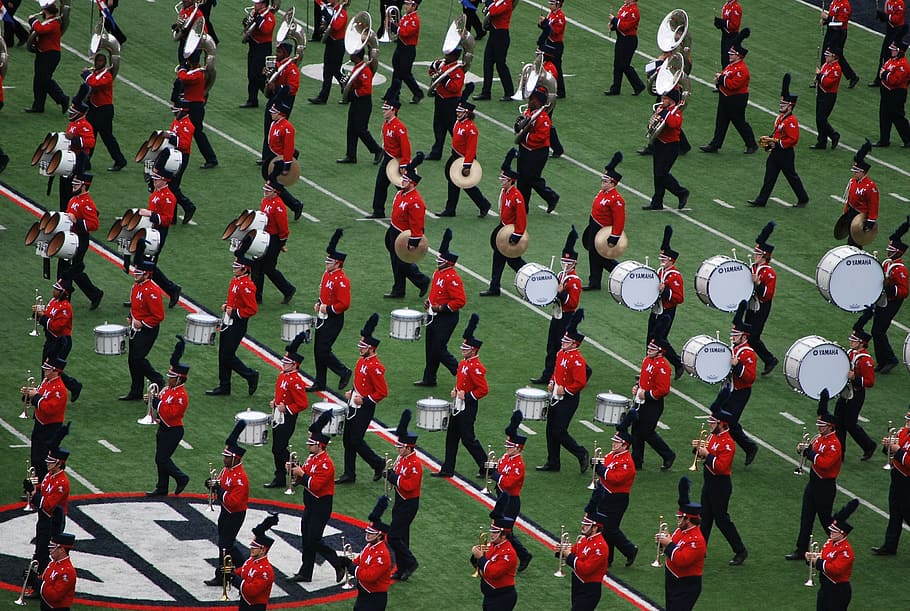 marching bands in middle of football field, drum, uniform, music