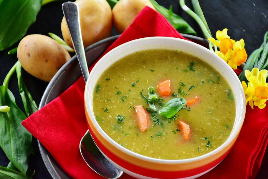 soup on white, orange, and red ceramic bowl, potato soup, bear's garlic