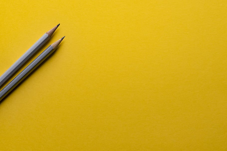 two gray pencils on yellow surface, background, designer, work
