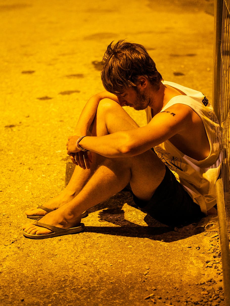 man sitting beside black fence, boy, thoughtful, teen, youth HD wallpaper