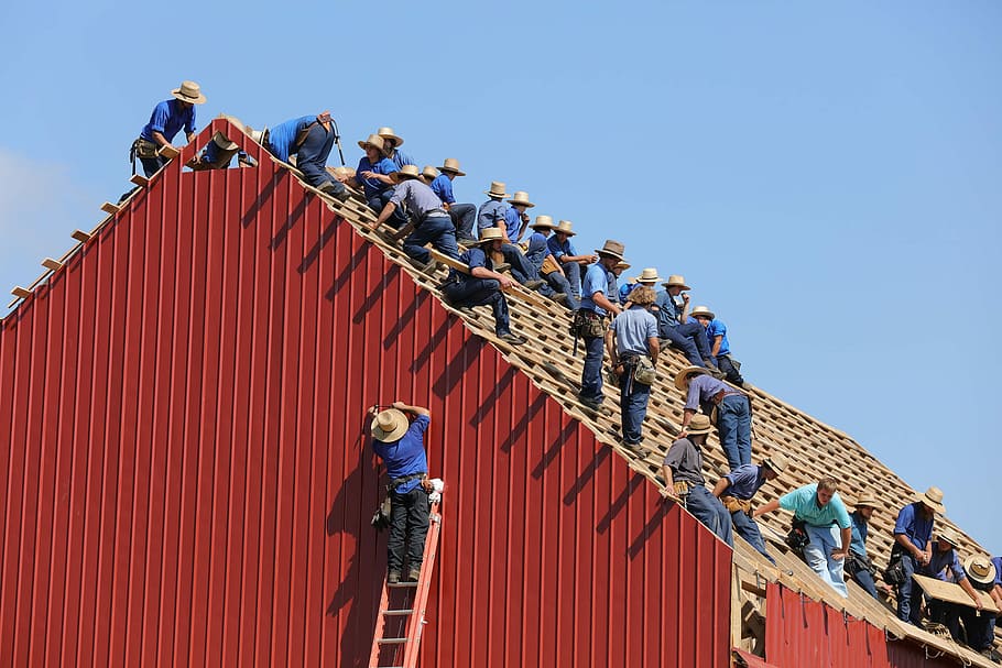 group of construction workers constructing house, group of men fixing house roof