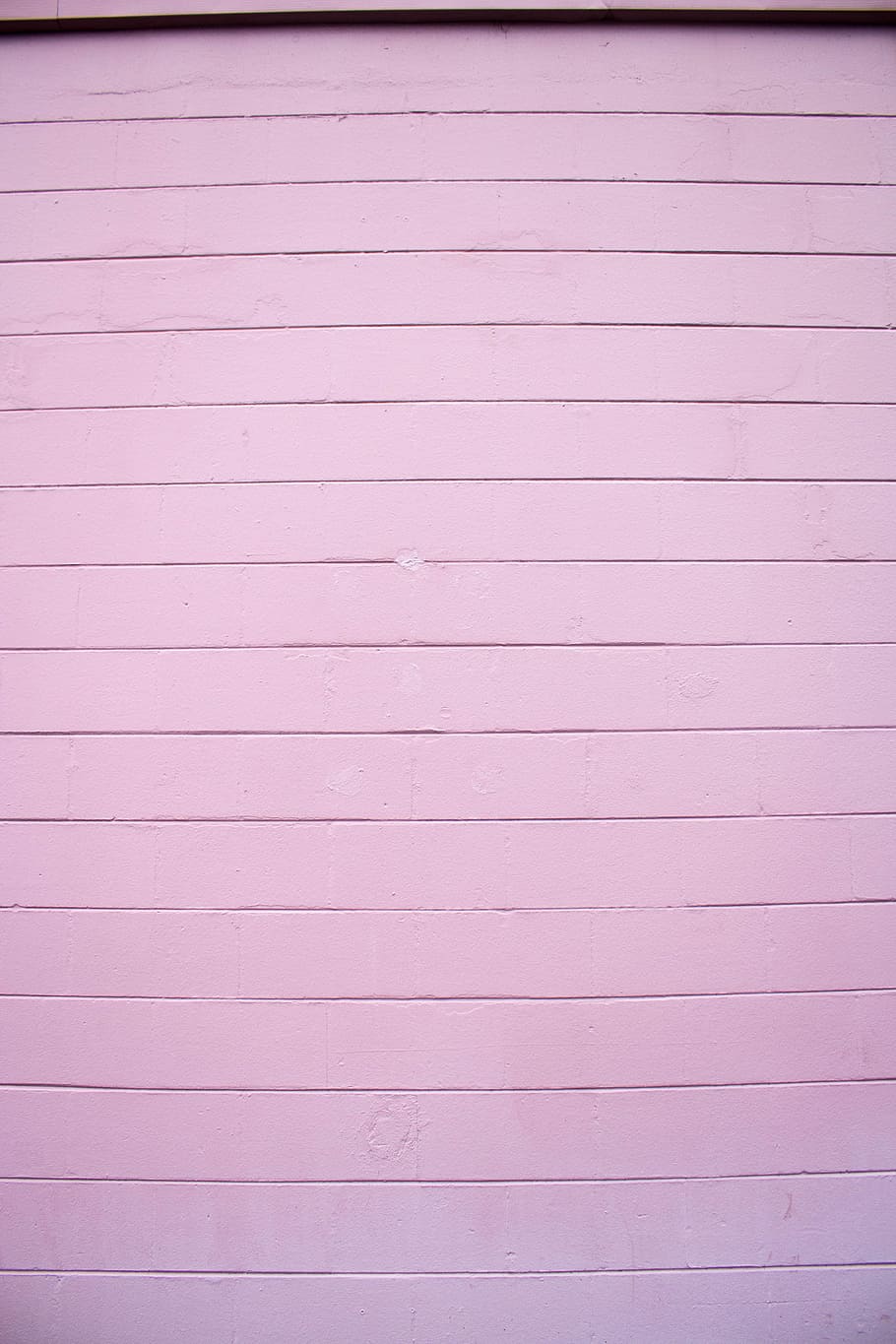 close shot of white wooden wall, pink concrete wall, door, texture