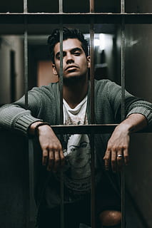 man on fence, man behind bars, jail, prison, portrait, one person HD wallpaper