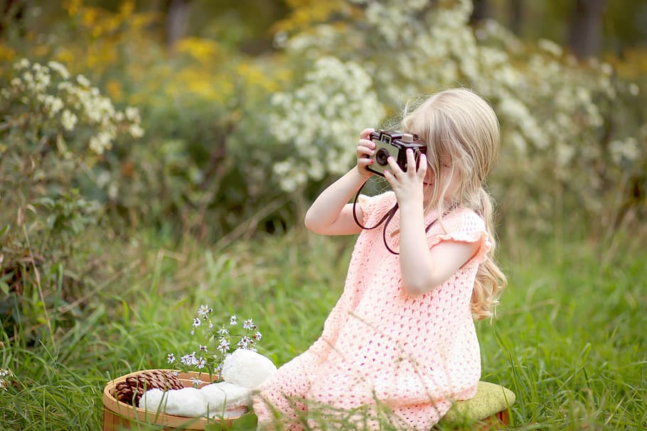 girl sitting on grass field holding black camera, nature, plants HD wallpaper