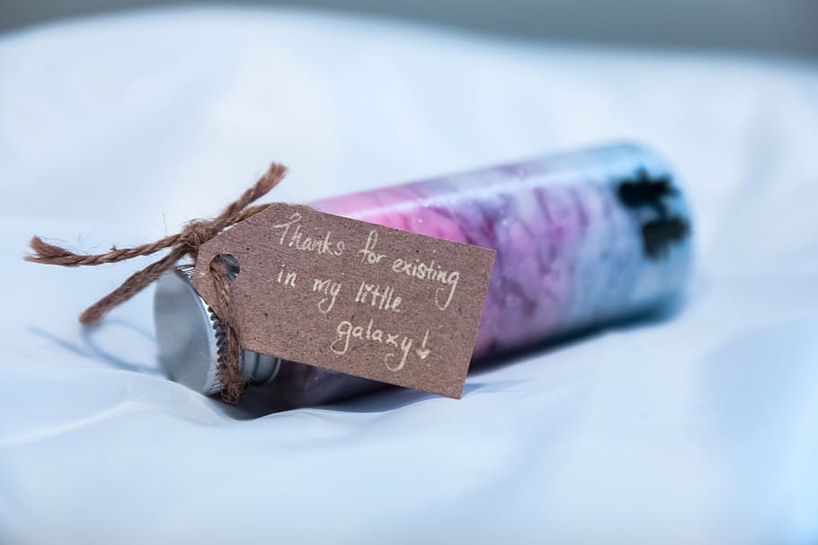 decorative bottle on its side on white textile, shallow, focus HD wallpaper
