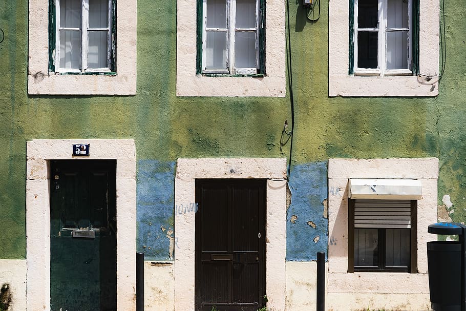 white roll-up door window, closeup photo of green and white concrete building HD wallpaper