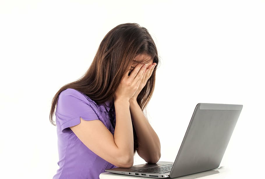 woman in purple top sitting in front of gray laptop computer HD wallpaper