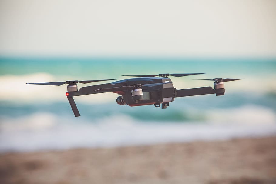 fryling black drone in selective fucos photography, time lapse photography of flying black quadcopter drone HD wallpaper