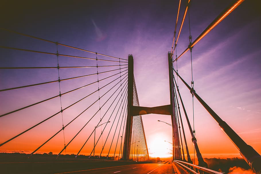 Haunting Sunrise, silhouette of cable-stayed bridge during golden hour HD wallpaper
