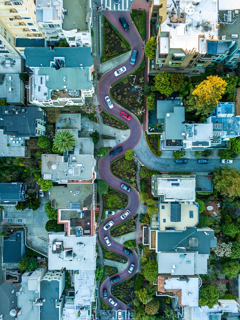 curved road during daytime, birds eye view of zig zag road, city