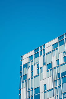 low angle photography of white and teal painted building, photo of white and blue high-rise building HD wallpaper