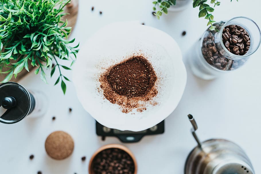 clear glass jar with coffee beans on white table, top view photo of brown coffee powder on white filter HD wallpaper