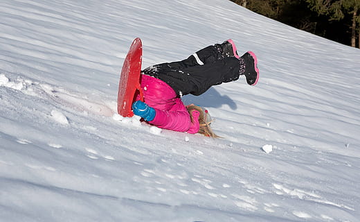 Royalty-Free photo: Woman riding on orange board sliding on snow